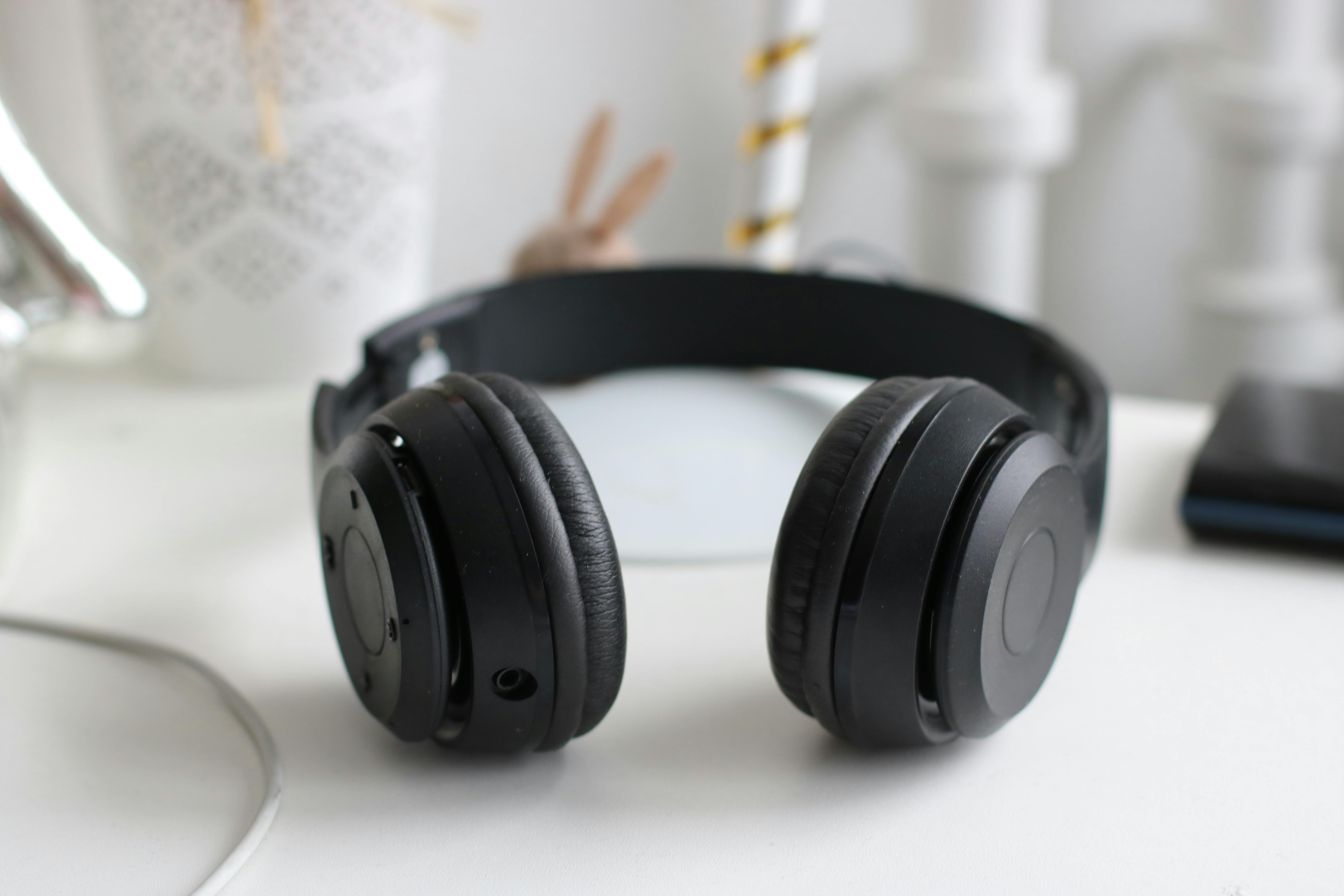 Black headphones on a white desk