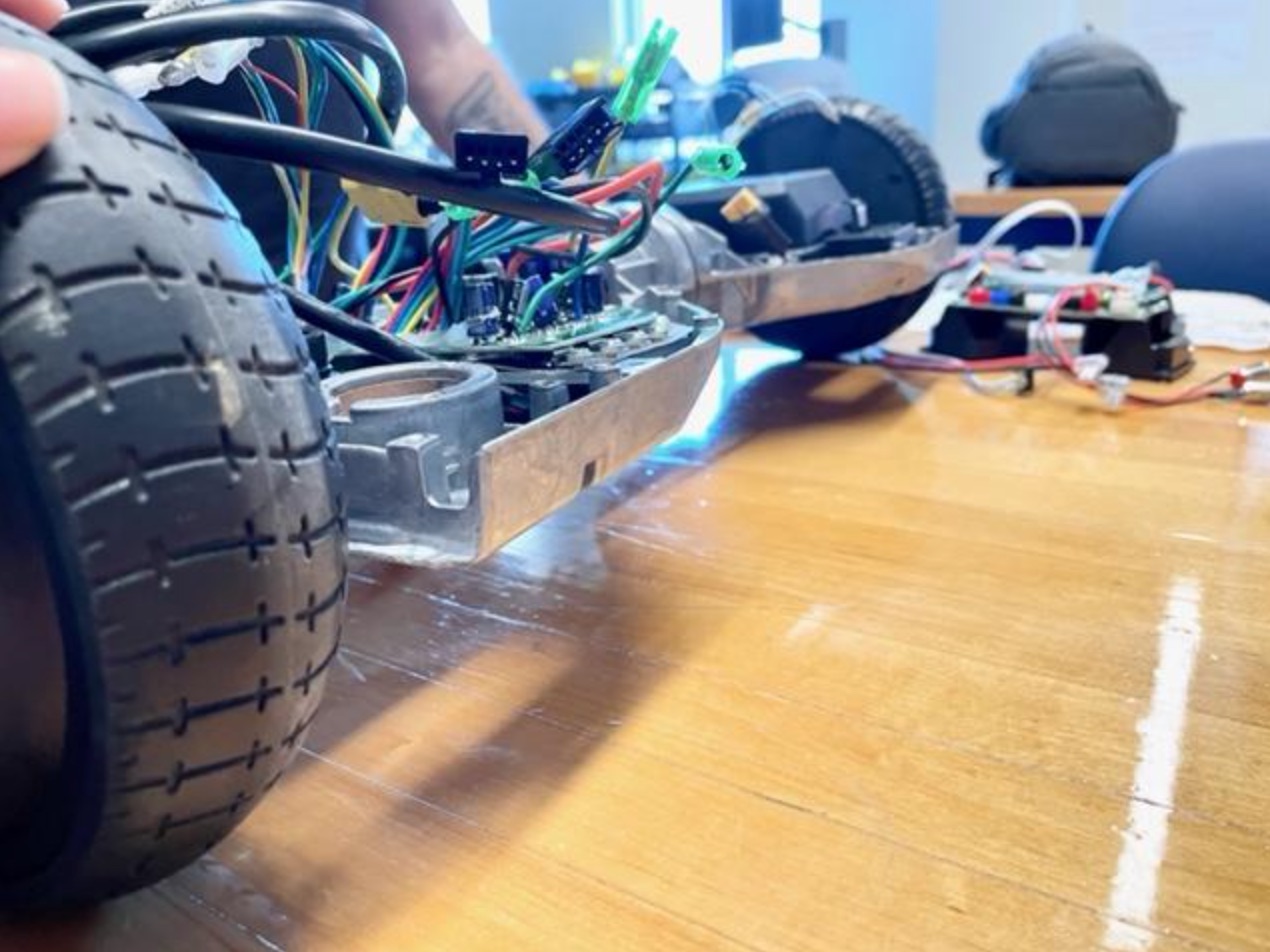 Extreme close-up of a wheeled toy car, showing the wires and switches